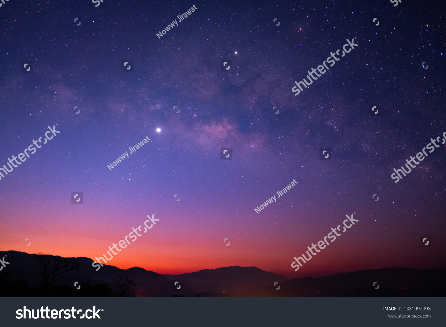 Milky Way galaxy with Jupiter Venus and Saturn over the wildfire mountain at dawn #1381992998