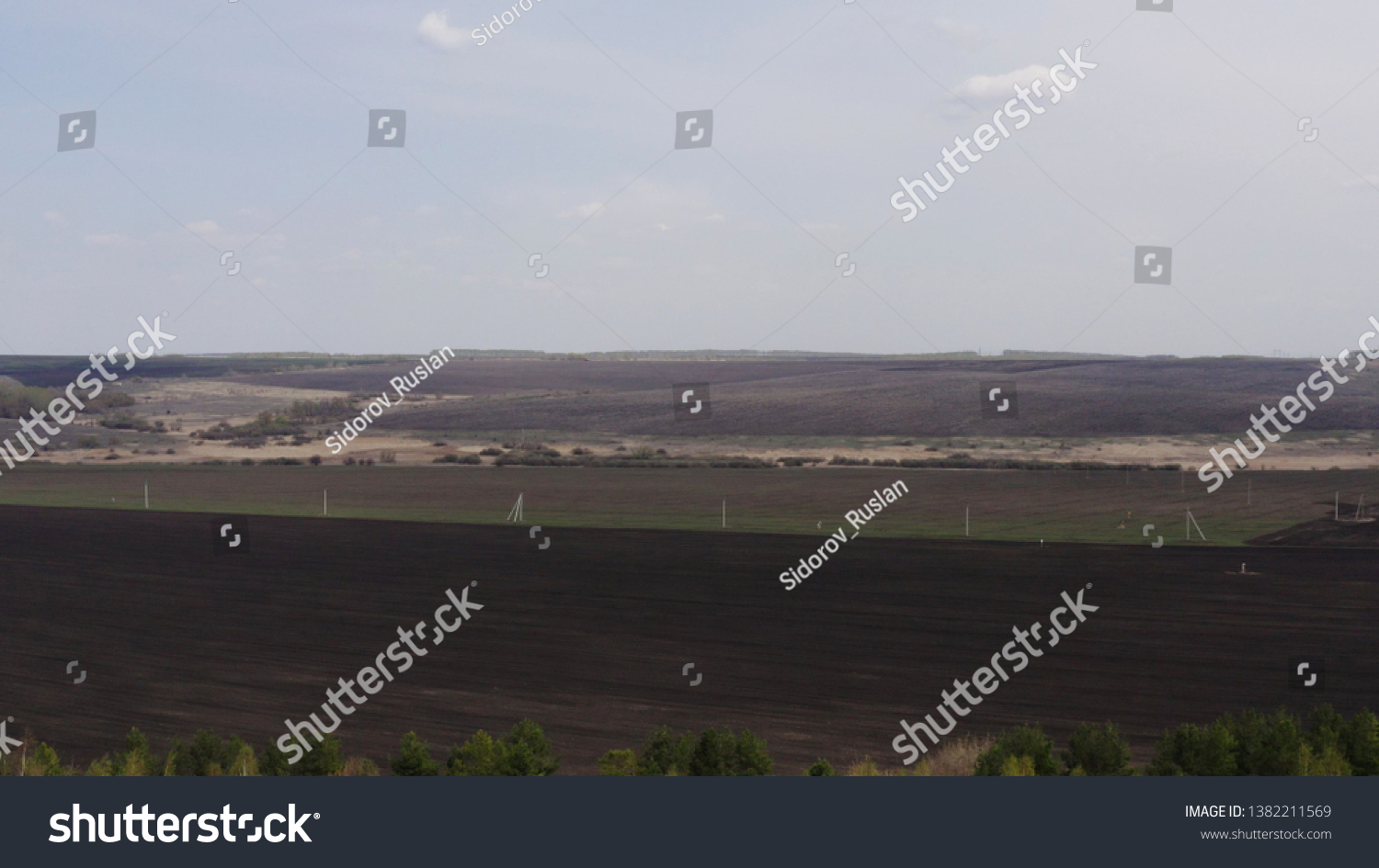 Aerial survey of arable land. Plowed field. Fertile land of arable land. Sowing. Fly over the arable land. #1382211569