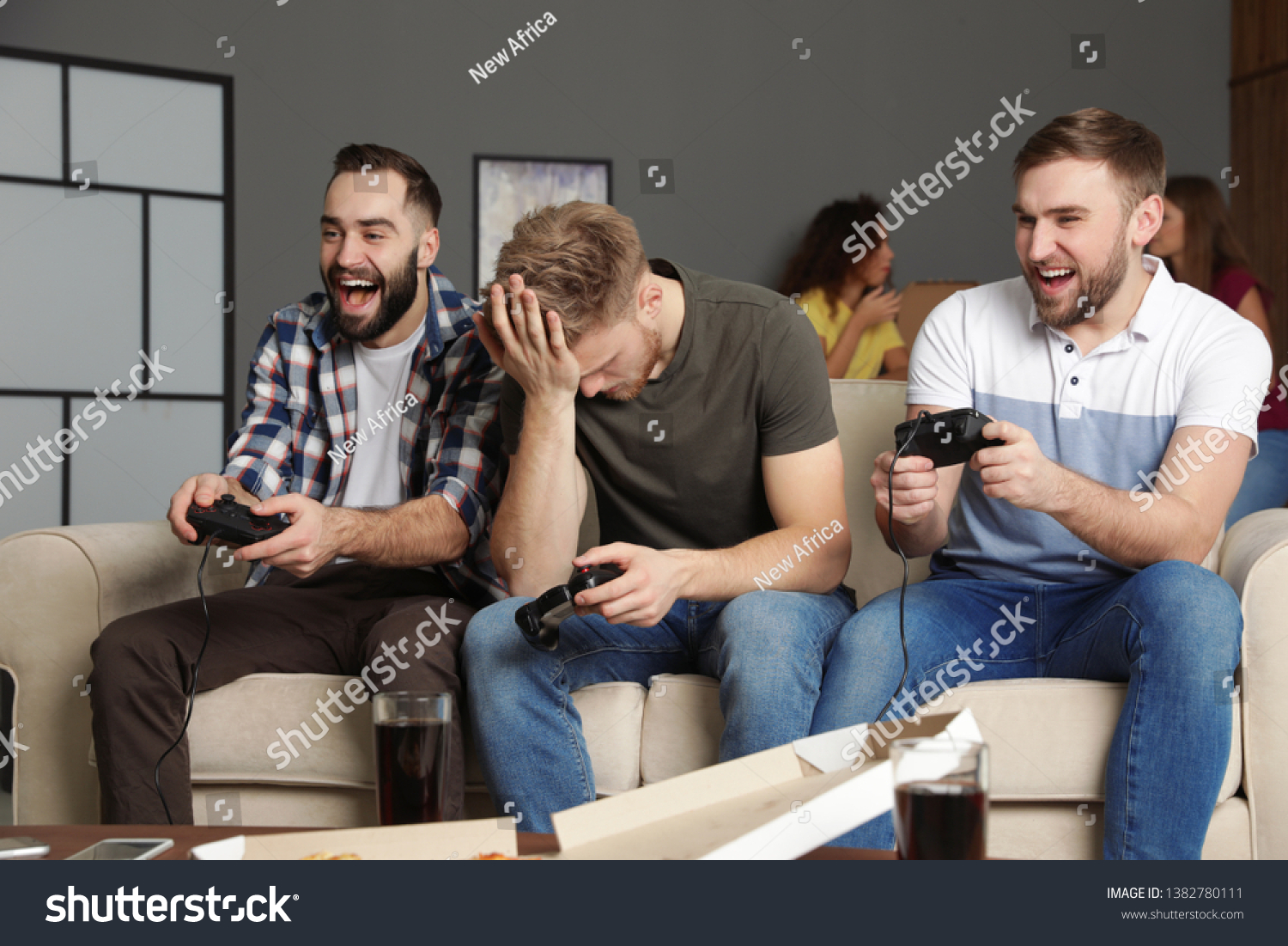 Emotional friends playing video games at home #1382780111
