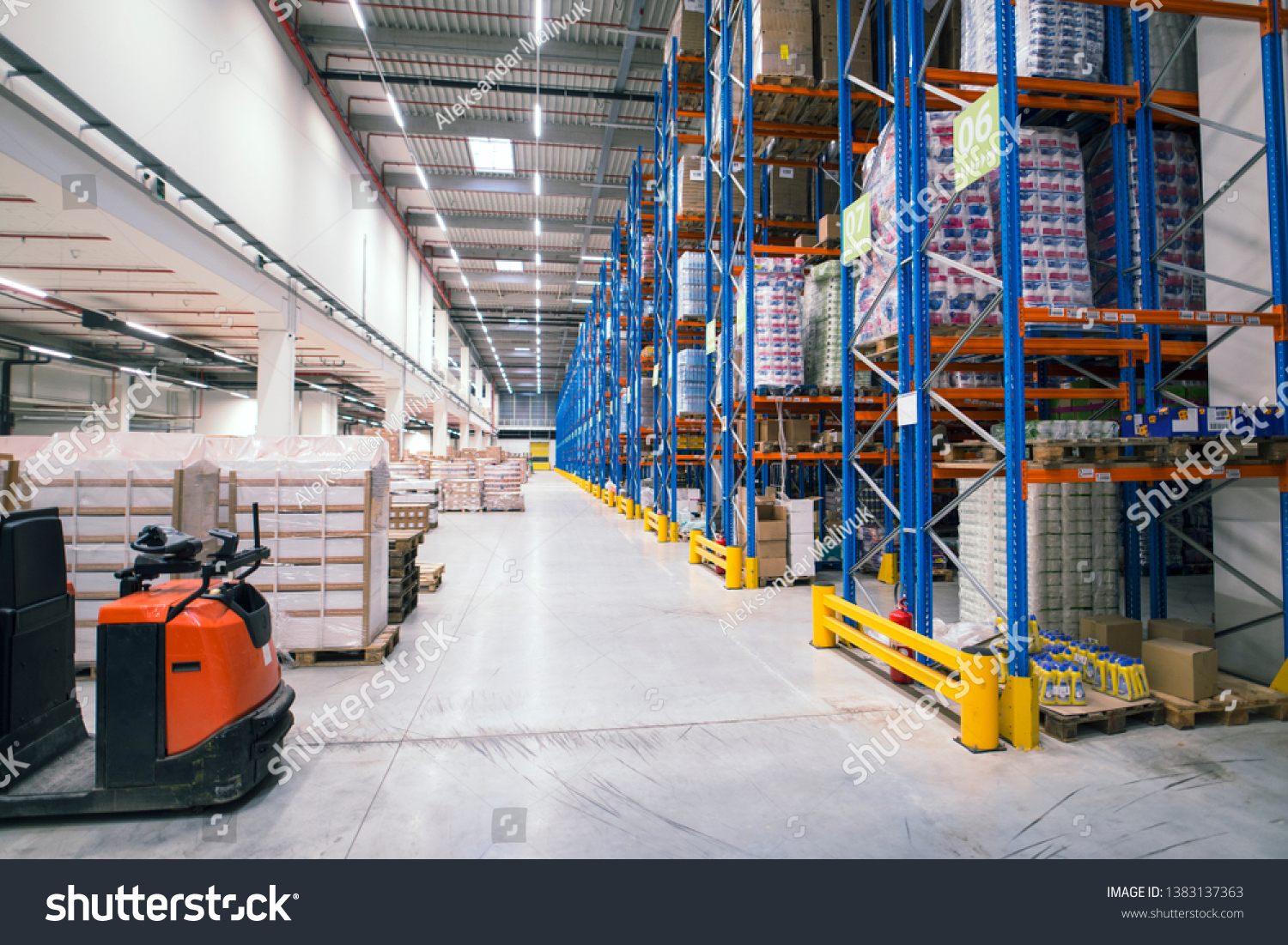 Warehouse storage facility interior. Large distribution center with shelves full of palette boxes and forklift machine. #1383137363