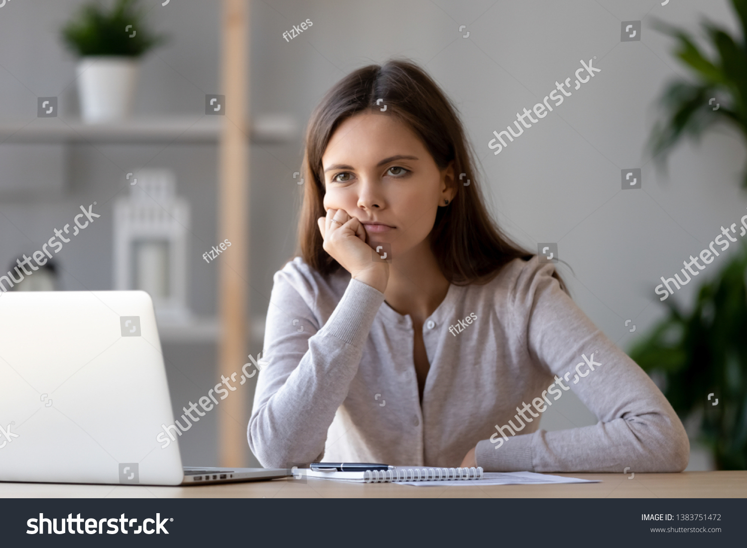Bored young woman sit at home office table look in distance unable to work at laptop, exhausted girl student feel unmotivated unwilling to study, distracted taking break. Dull monotonous job concept #1383751472