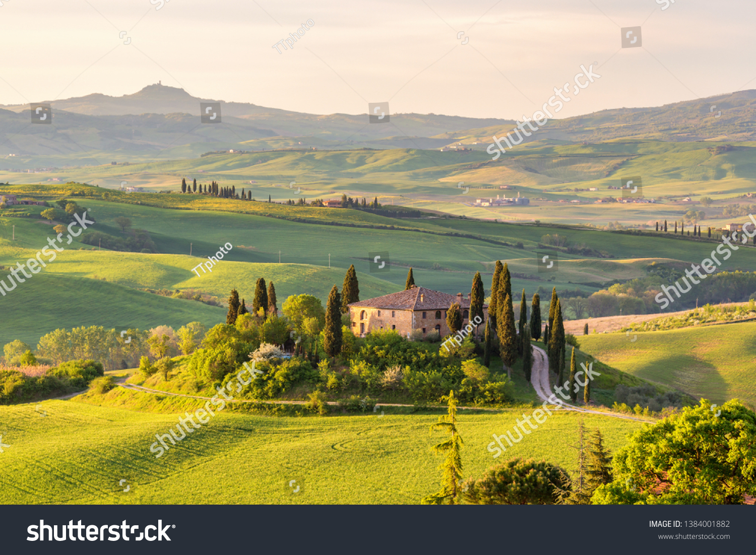 Farm house on a hill in Tuscany landscape #1384001882