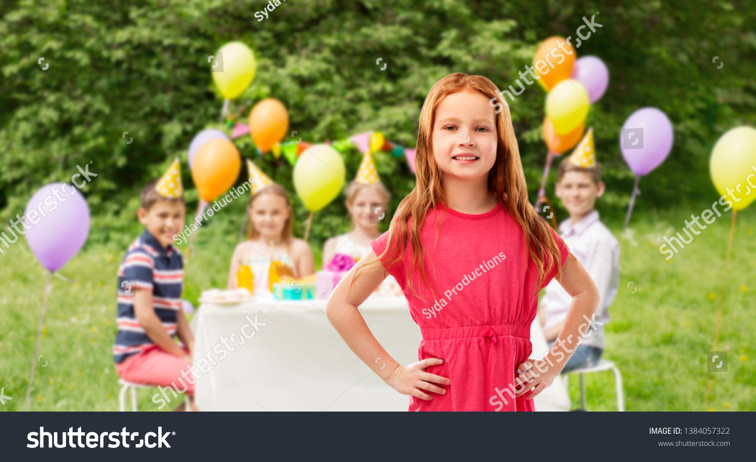 childhood and people concept - smiling red haired girl posing in pink dress over birthday party at summer park background #1384057322