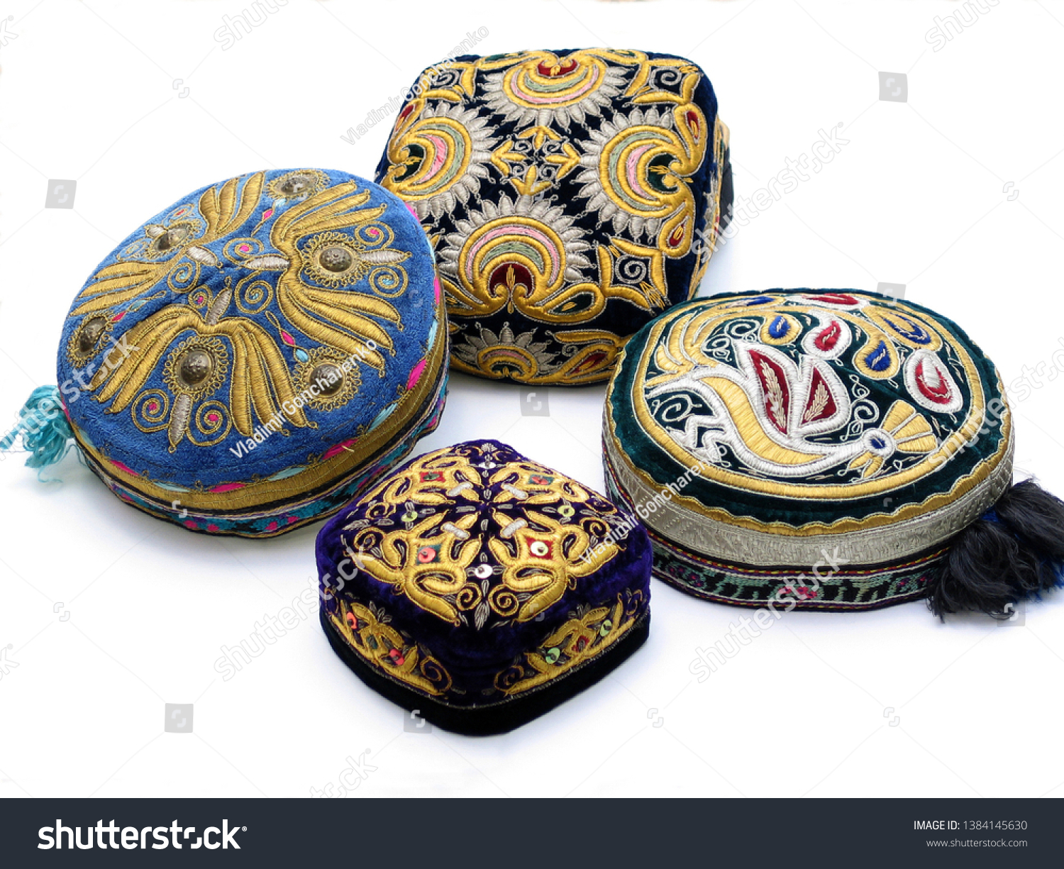 The traditional Uzbek hat, called a skullcap,or Duppi, is decorated with colorful embroidery on the white background    #1384145630