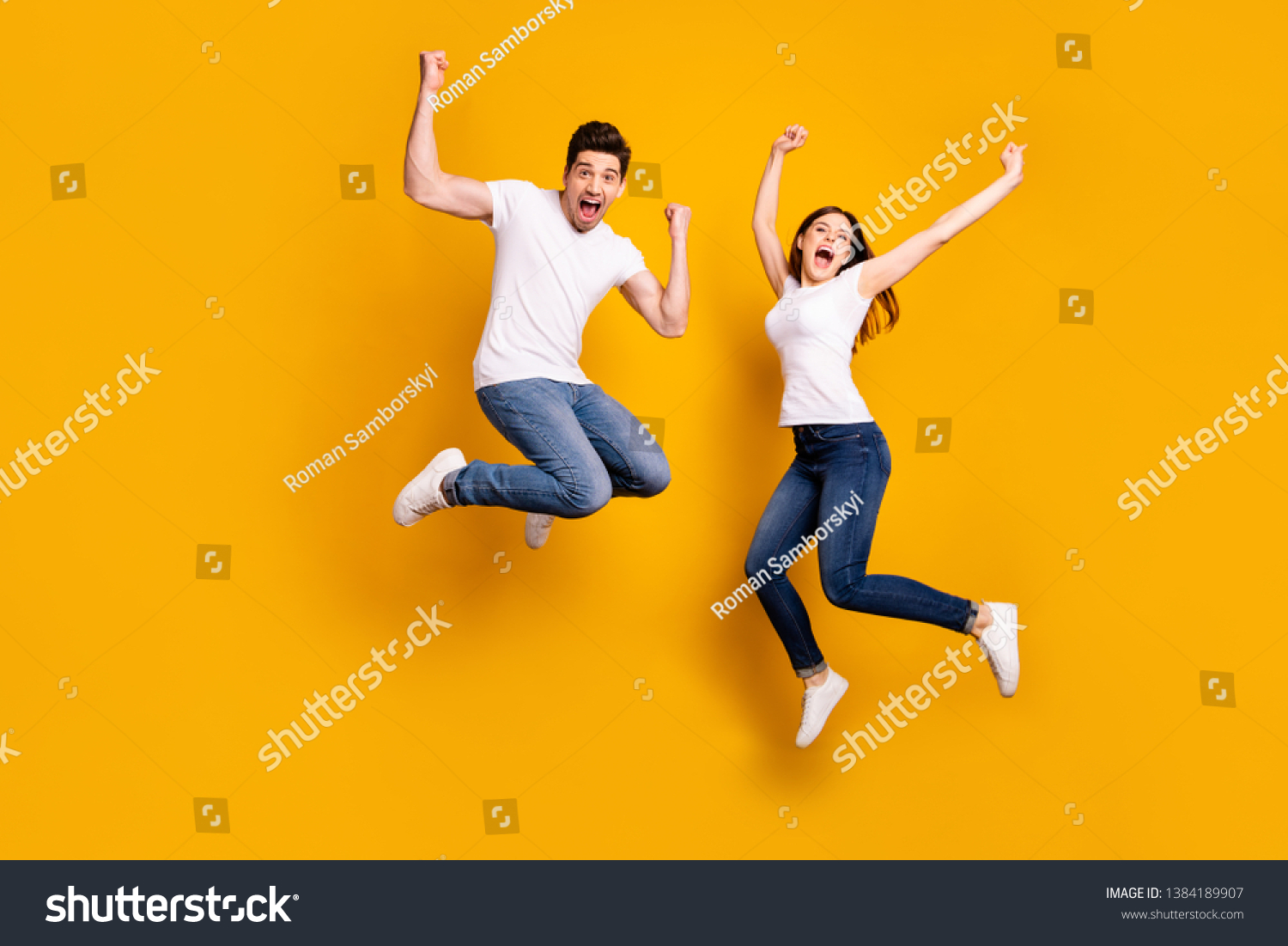 Full length body size photo funky she her he him his pair jumping high raised fists yell scream shout loud cheerleader football fans wear casual jeans denim white t-shirts isolated yellow background #1384189907