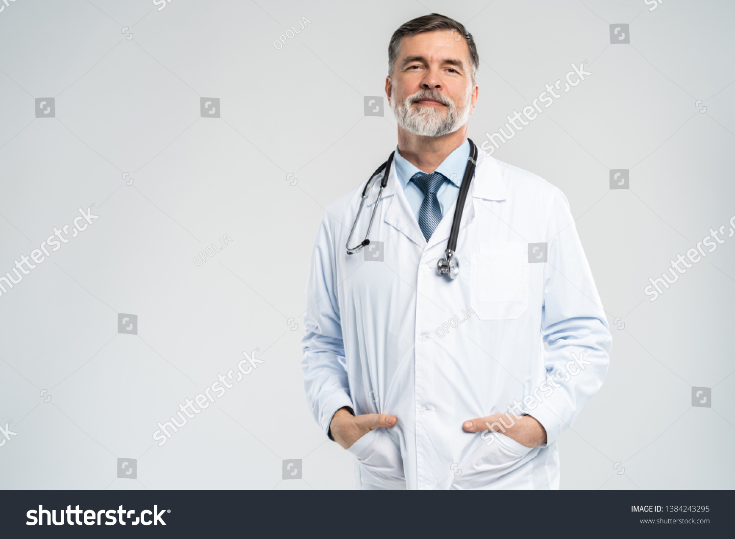 Cheerful mature doctor posing and smiling at camera, healthcare and medicine #1384243295