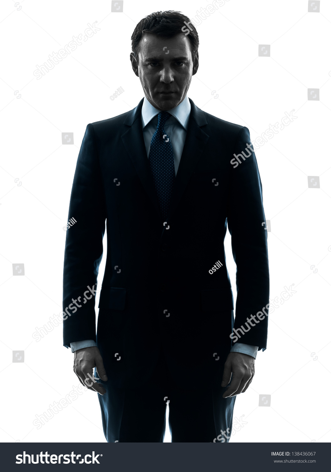 one caucasian business man serious looking at camera  in silhouette studio isolated on white background #138436067
