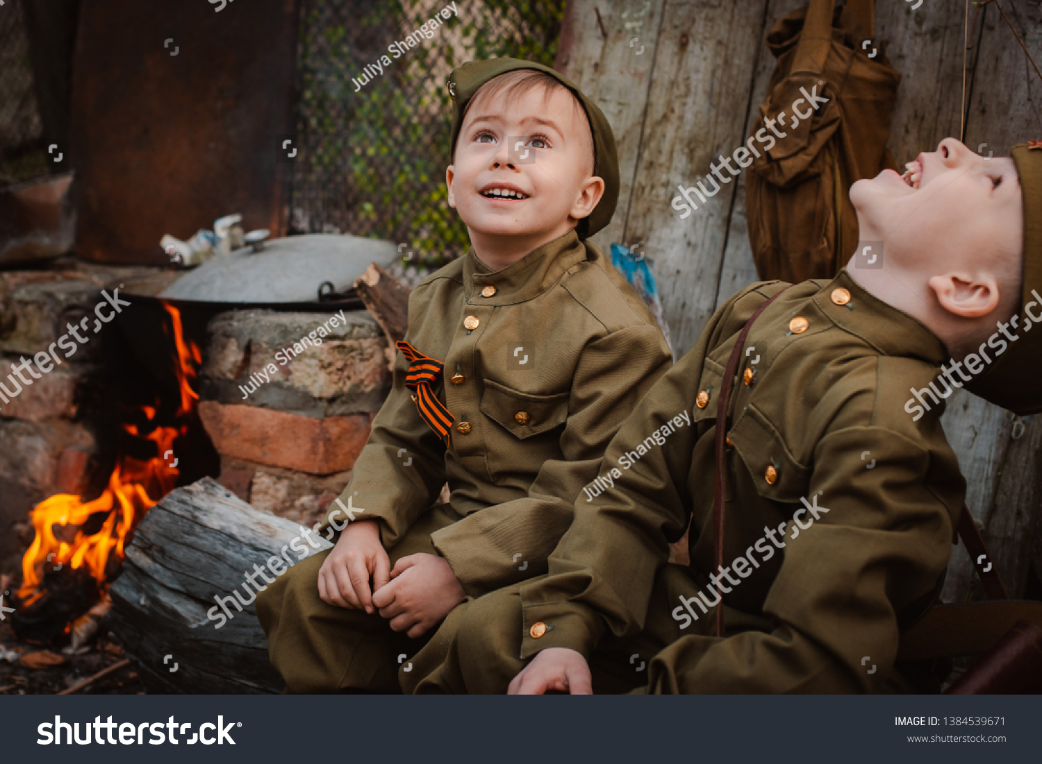 young child in military uniform on holiday day of victory, the scenery of wartime. Rustic style. Accordion, flag. May 9 2018, Russia, #1384539671
