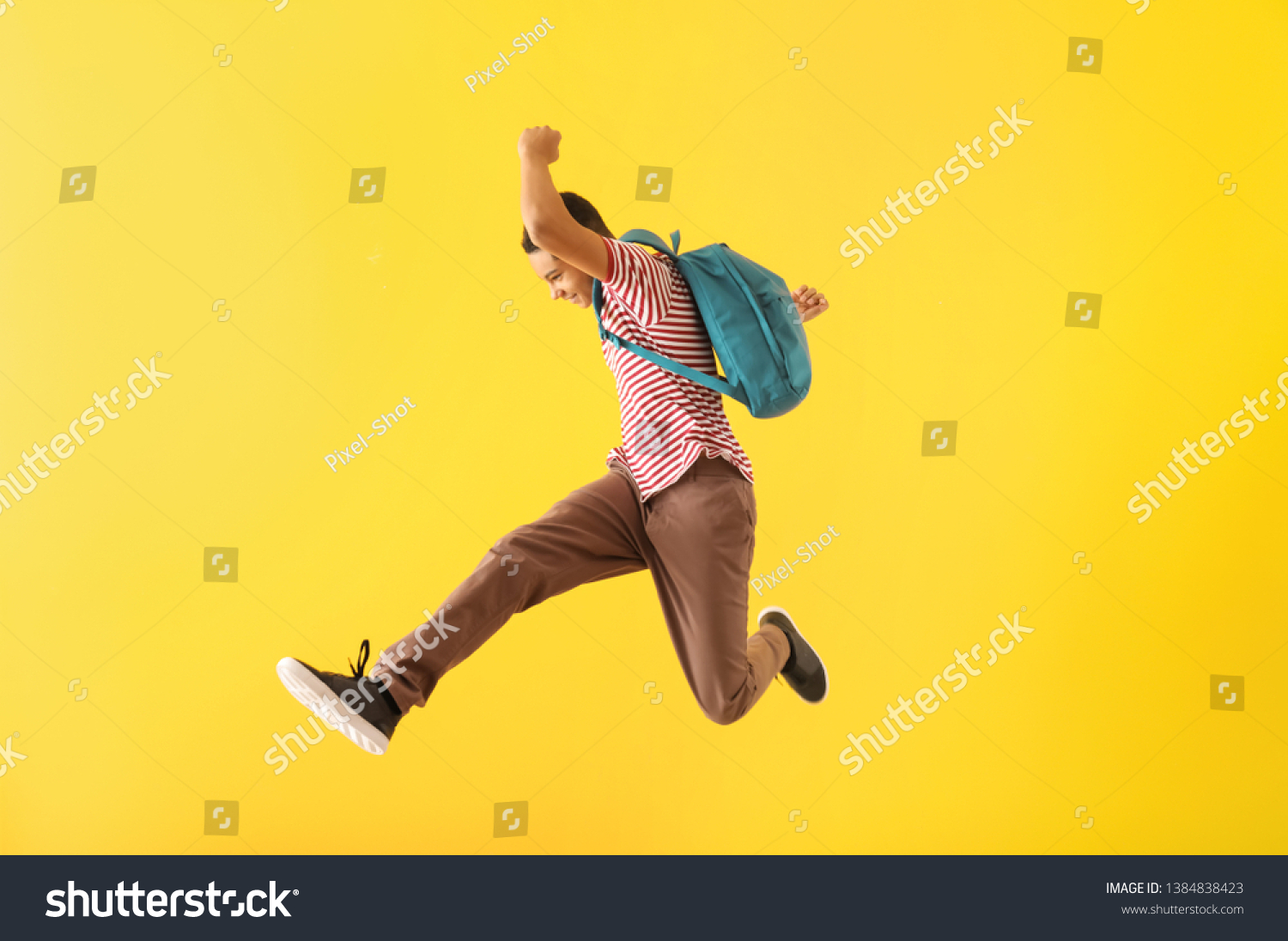 Portrait of jumping African-American teenage boy on color background #1384838423