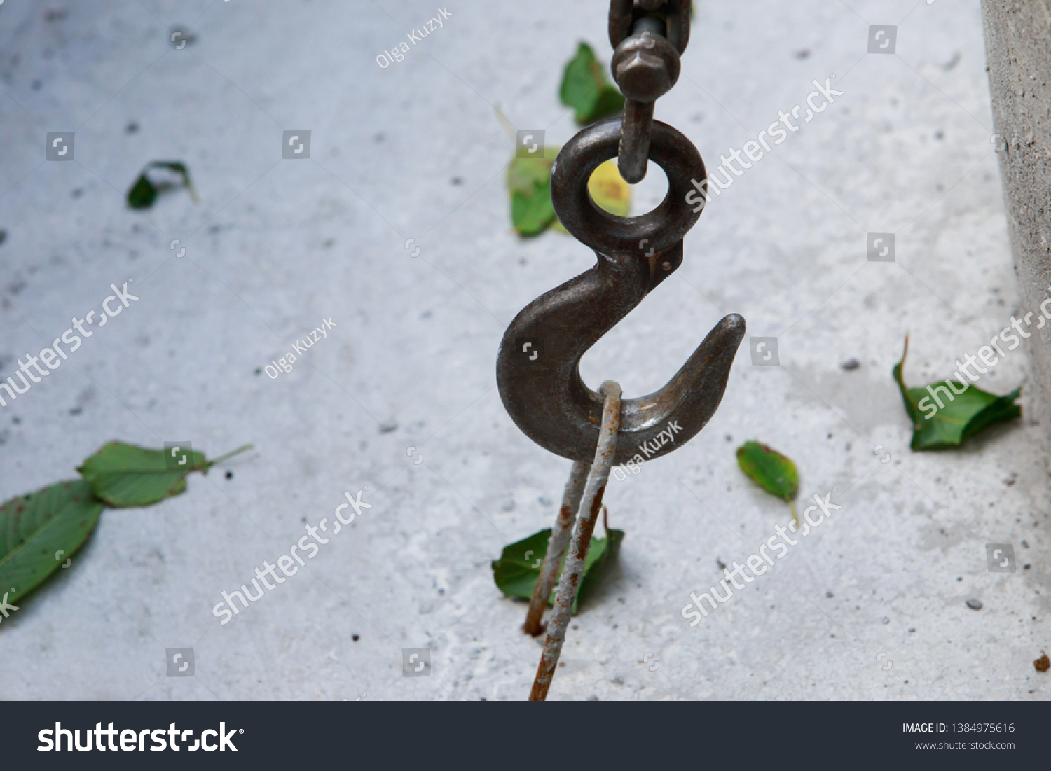 Large metal hook hooked on concrete structure #1384975616