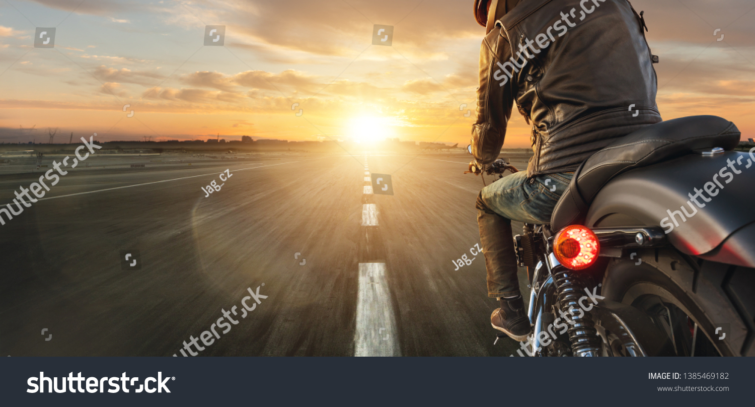 Motorcycle driver riding alone on asphalt motorway. Outdoor photography. Travel and sport, speed and freedom concept #1385469182