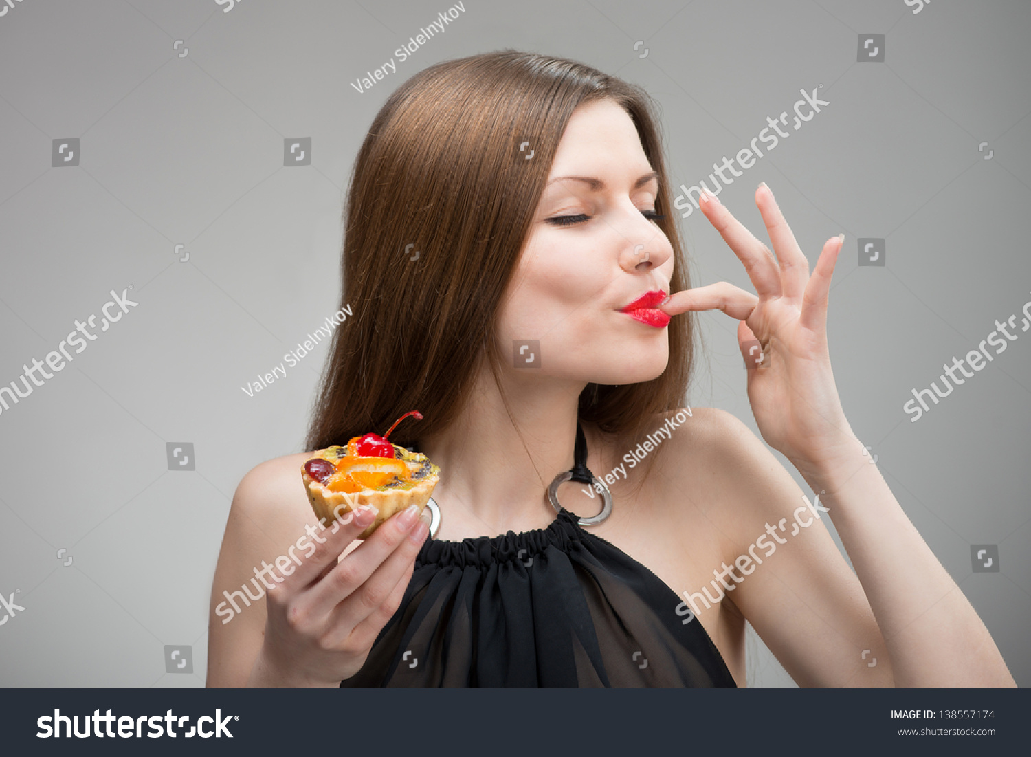 Portrait of young woman enjoying the cake #138557174