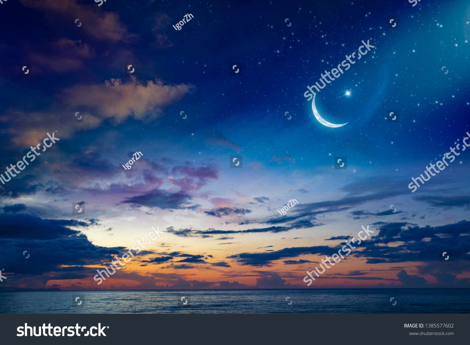 Ramadan Kareem background with crescent, stars and glowing clouds above serene sea.  Elements of this image furnished by NASA #1385577602