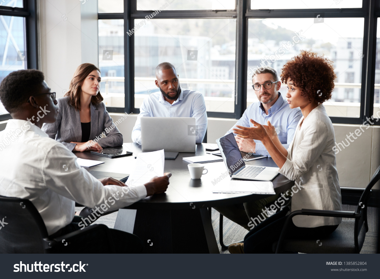 black businesswoman addressing colleagues at a corporate business meeting, close up #1385852804