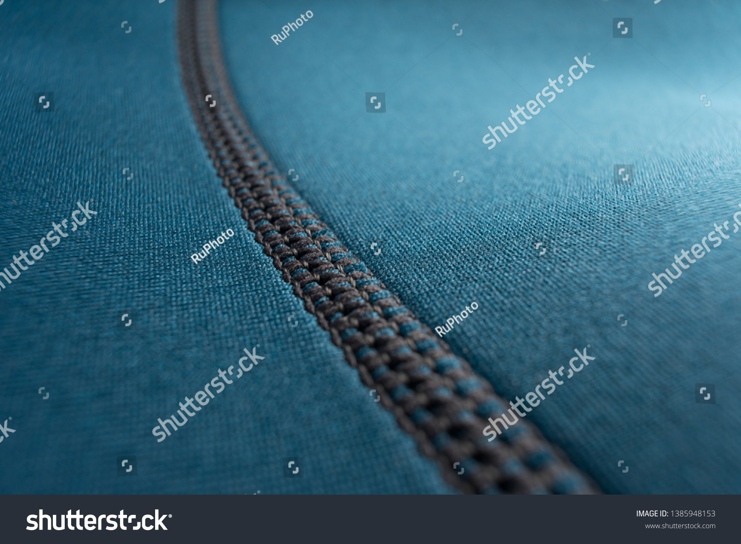 Close up of stitching along the seam of a blue neoprene scuba diving wetsuit #1385948153