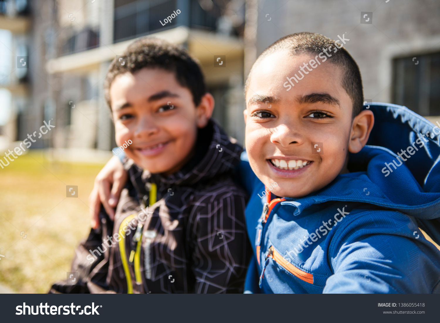 The Children Smiling outside in spring season with coat #1386055418