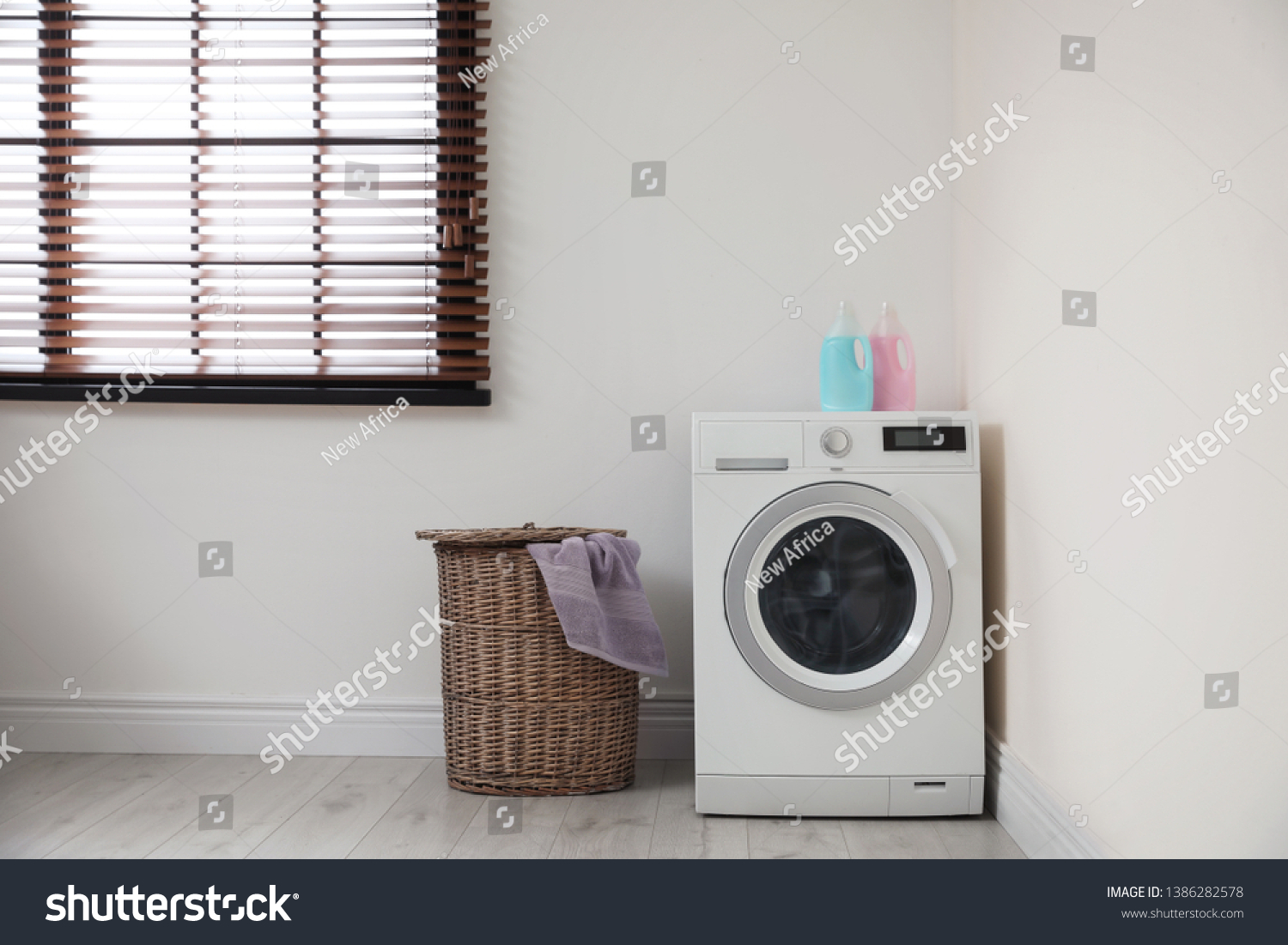 Modern washing machine and laundry basket indoors #1386282578