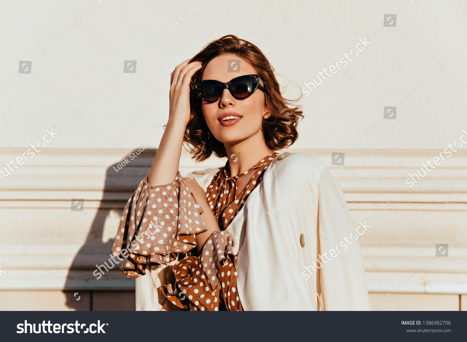 Lovely woman in vintage outfit expressing interest. Outdoor shot of glamorous happy girl in sunglasses. #1386982706