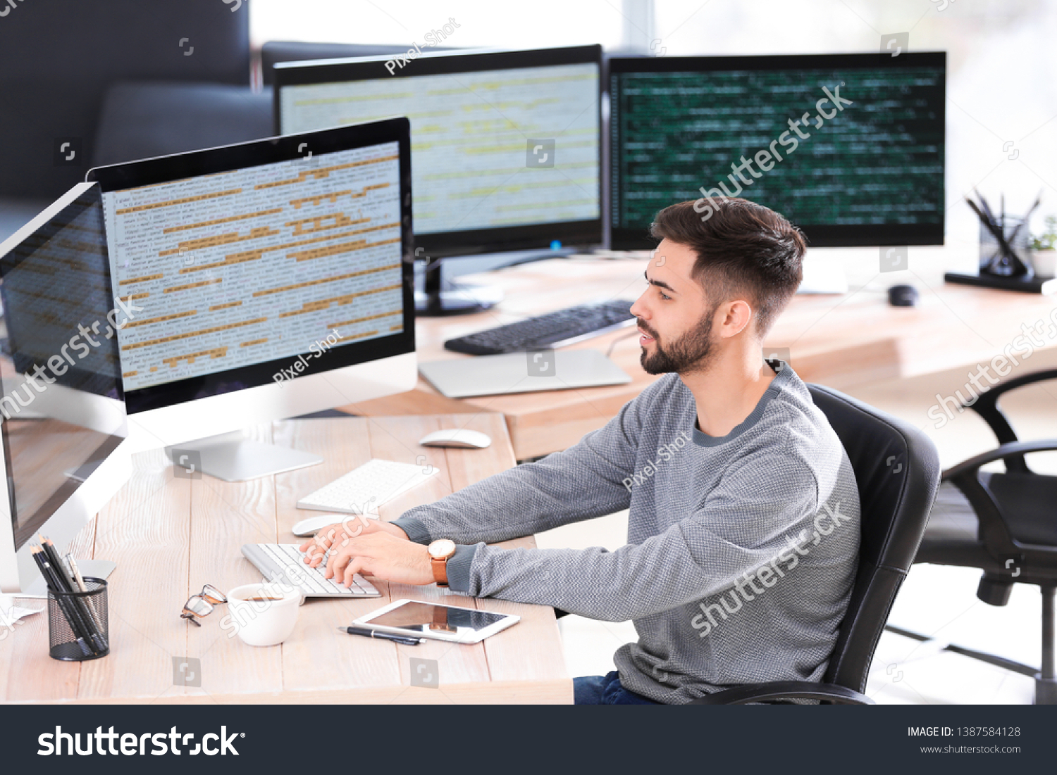 Male programmer working in office #1387584128