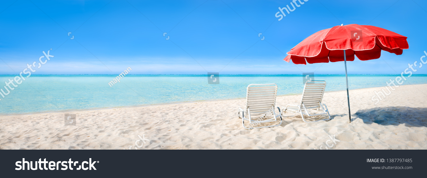 Beach panorama with sun chairs and parasol as background image #1387797485