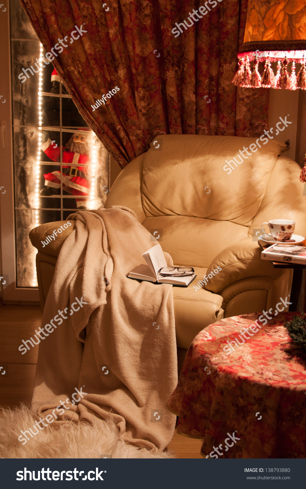 Cozy interior of the house.  A comfortable chair with a blanket, a book and a coffee. #138793880