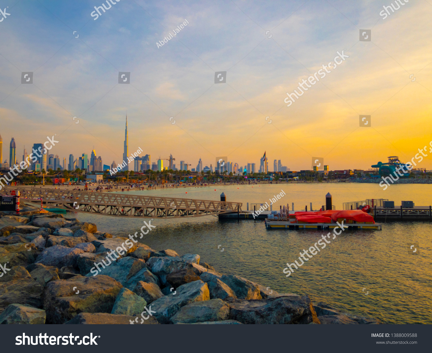 La Mer in Dubai, UAE - April 16, 2019: La Mer at sunset: People rest on the beach. It is a beachfront in Jumeirah. DUBAI, UAE. #1388009588