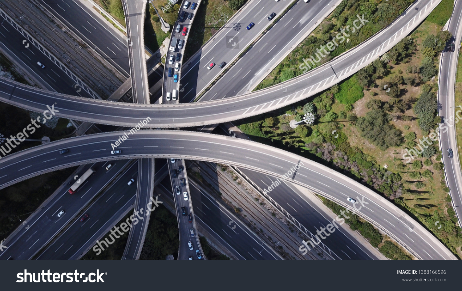 Aerial drone view of popular highway multilevel junction road, passing through National motorway in traffic jam #1388166596