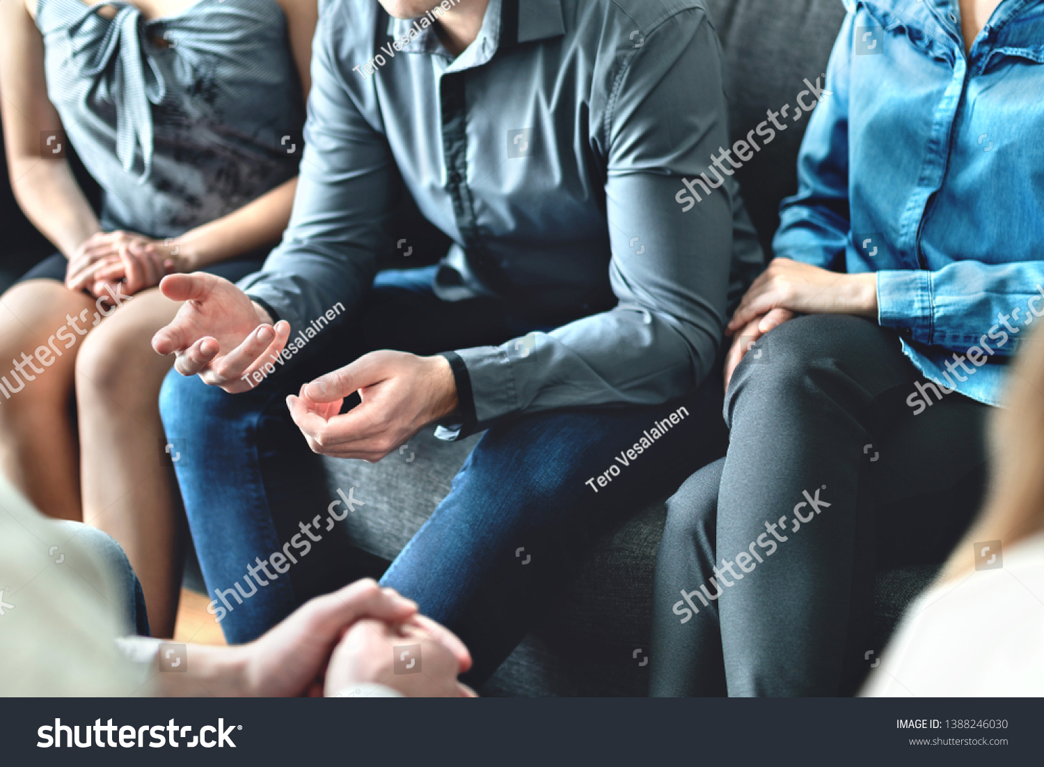 Counseling and conversation in group therapy or meeting. Man sharing story to community. Casual business people in discussion. Peer support, trust and empathy. Treatment together in help center. #1388246030