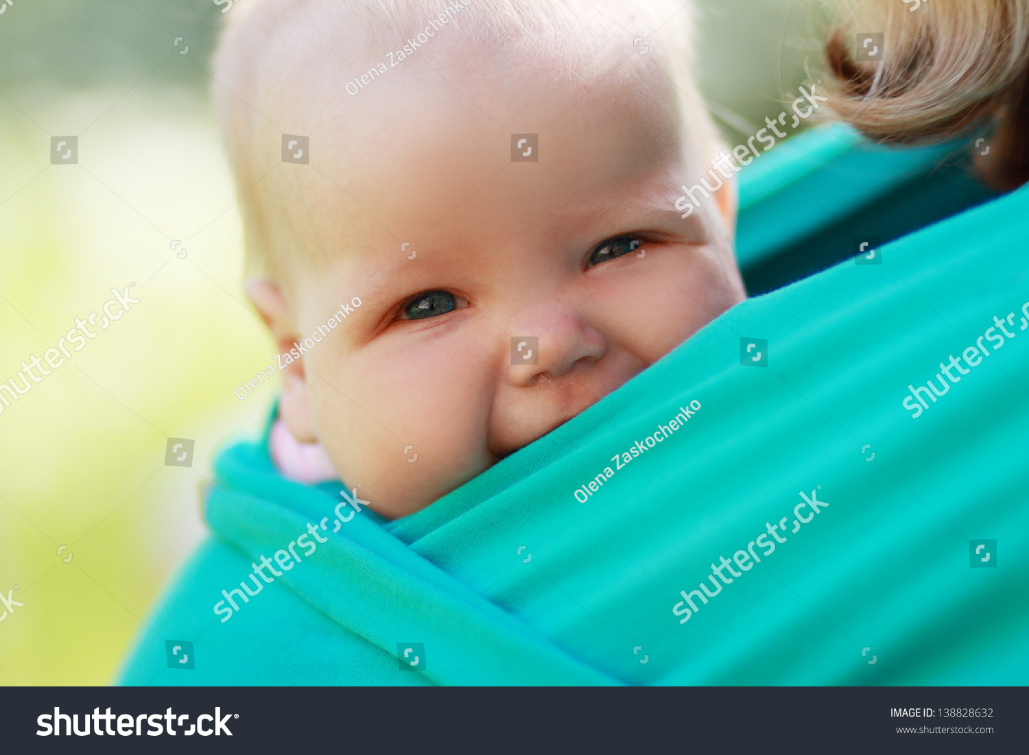 Smiling baby closed to mom in sling outdoor #138828632