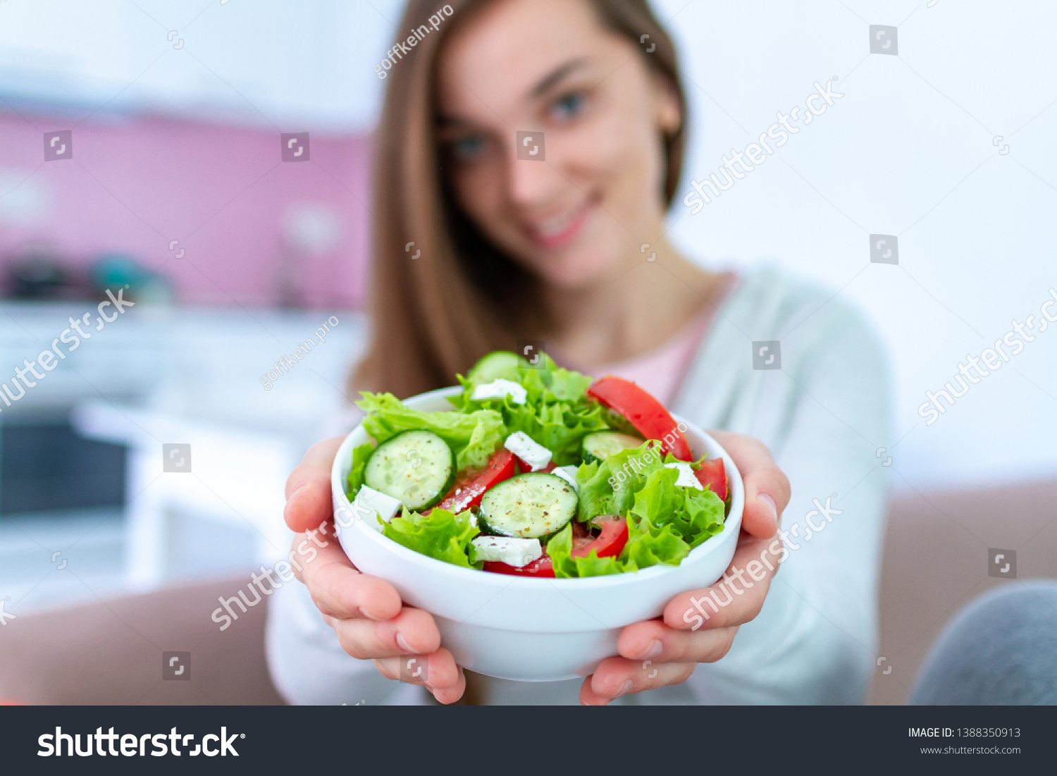 Healthy vegan woman holding a bowl of fresh vegetable salad. Balanced organic diet and clean eating. Healthy lifestyle #1388350913