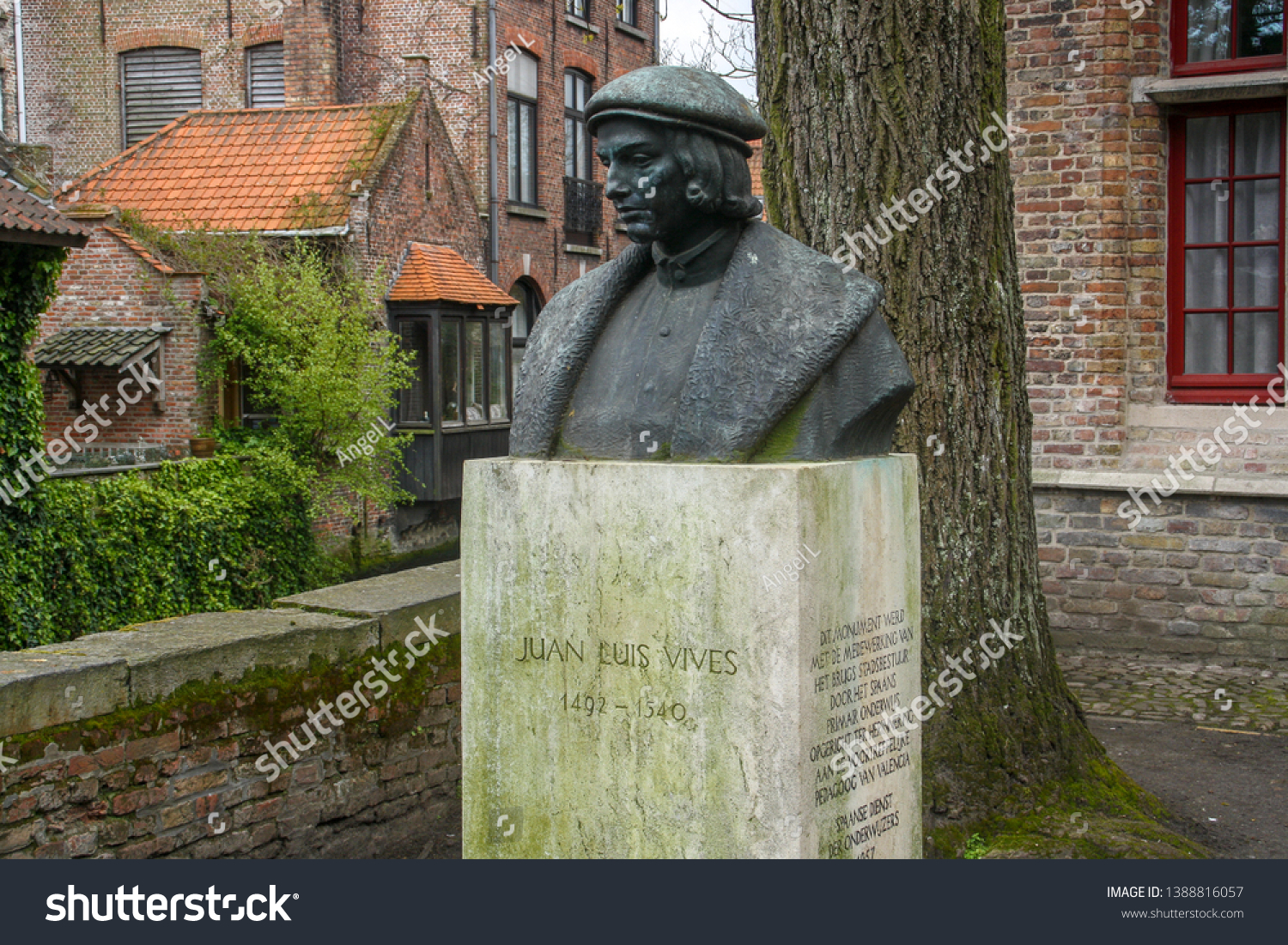 Bruges, Belgium; 04 28 2016. Bust of Juan Luis Vives in Bruges. Located behind the Church of Our Lady, next to a small canal and surrounded by trees #1388816057