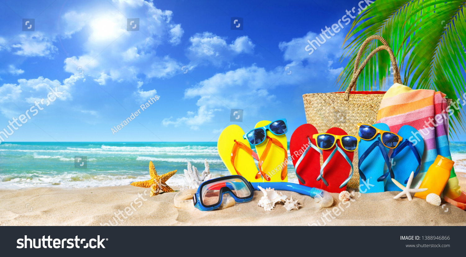 Tropical beach with sunbathing accessories, summer holiday background. Travel and beach family vacation #1388946866
