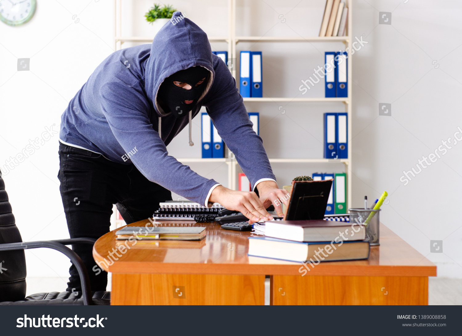 Male thief in balaclava in the office  #1389008858