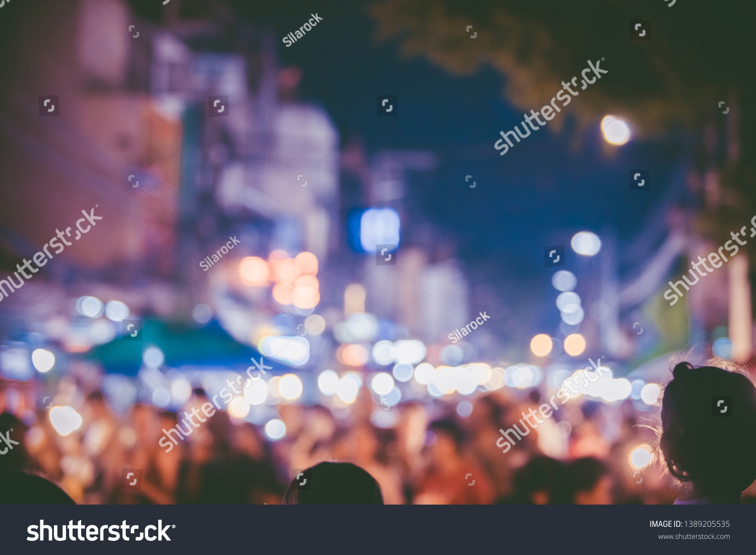 Abstract Blurred image of  people walking in the street at night,bokeh at Walking Street Market,Bokeh background and many people #1389205535