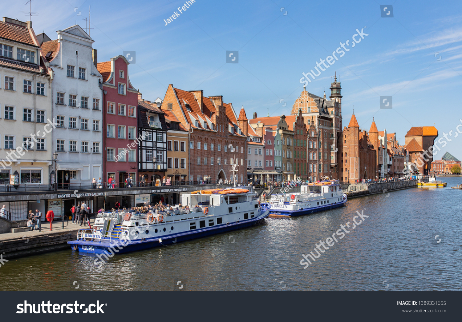 Gdansk, Poland - 20 April 2019: Old town of Gdansk, Motlawa river and popular promenade with tourist ships offering sightseeing trips. #1389331655