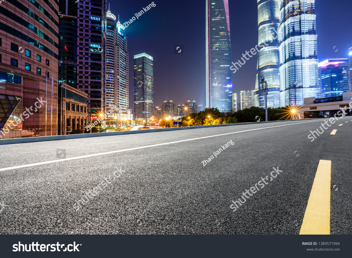 Shanghai modern commercial office buildings and empty asphalt highway at night #1389571994