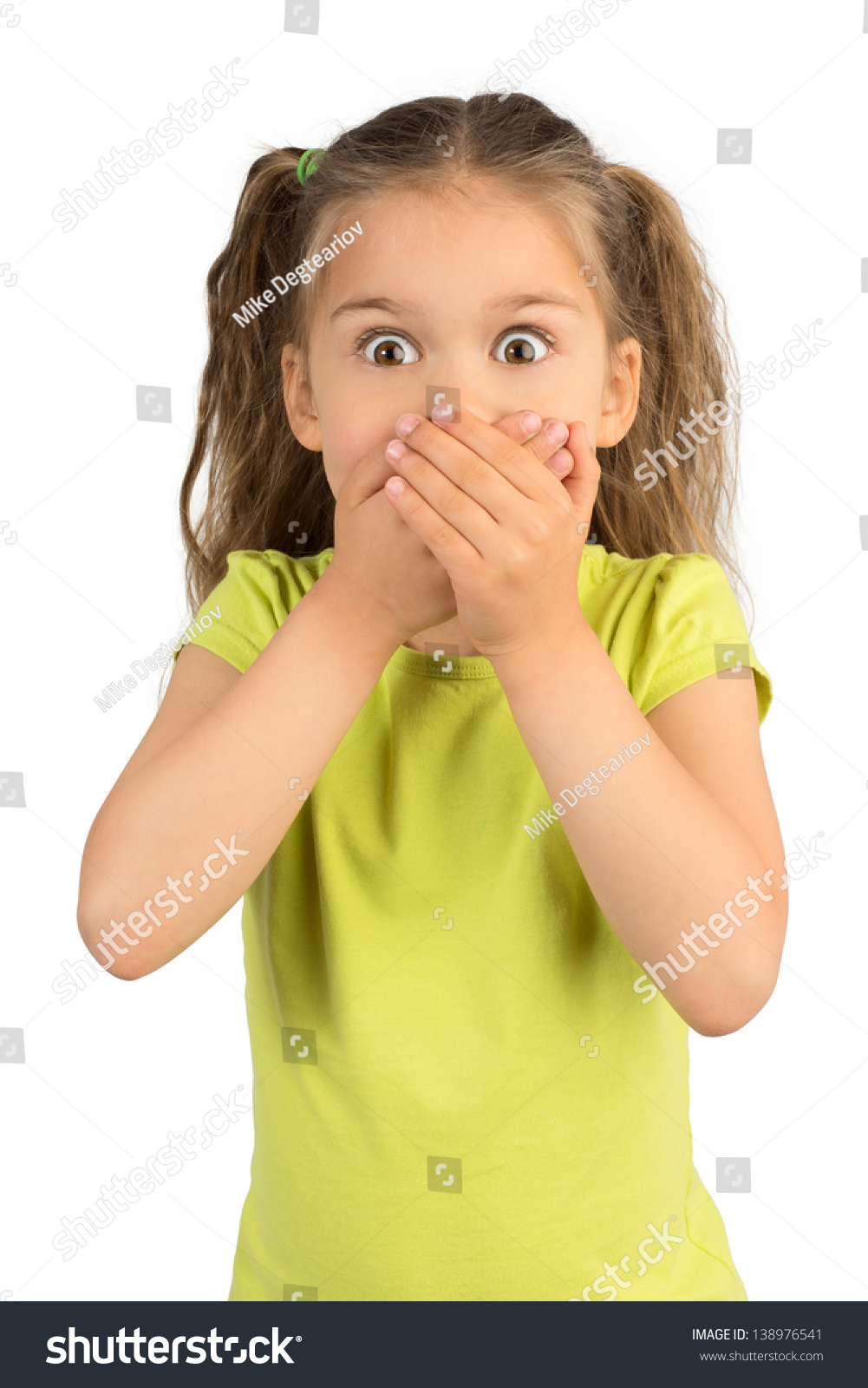Cute Little Girl Covering Her Mouth Showing Intense Expression of Fear and Terror, Isolated #138976541