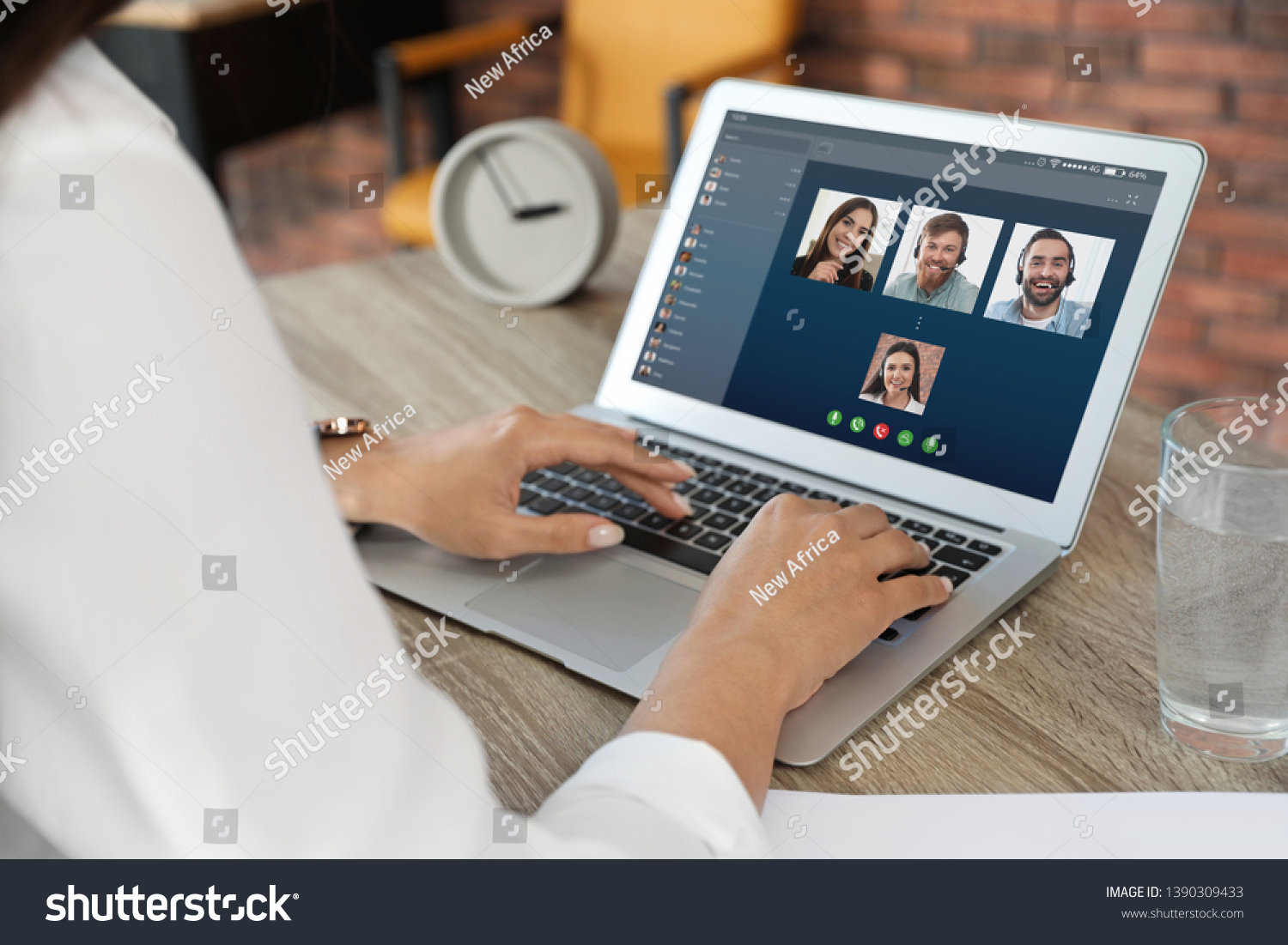 Woman having video chat with colleagues at table in office, closeup #1390309433