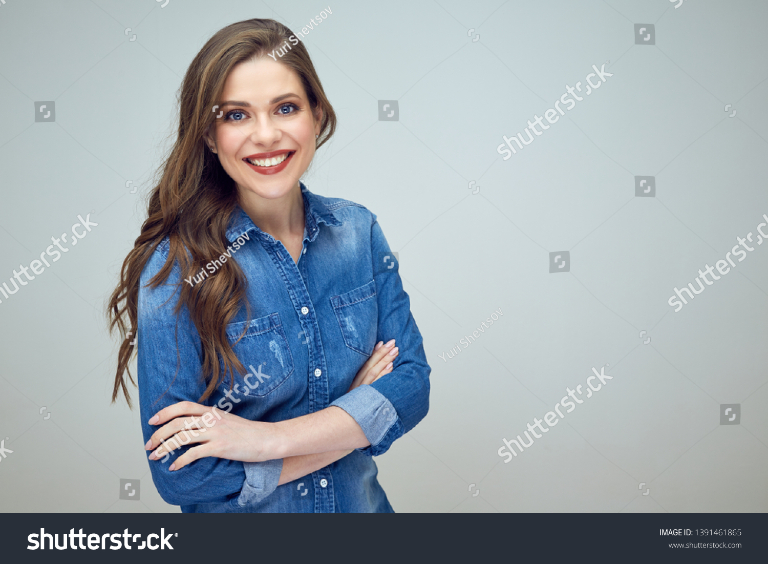 beautiful young woman with crossed arms. isolated portrait. #1391461865