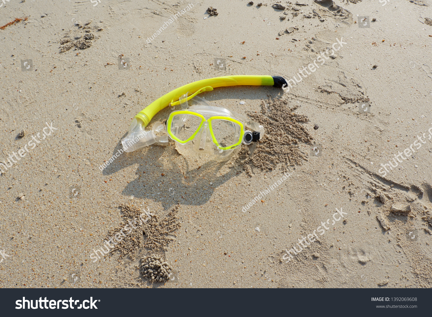 Snorkel and scuba mask on the beach. #1392069608