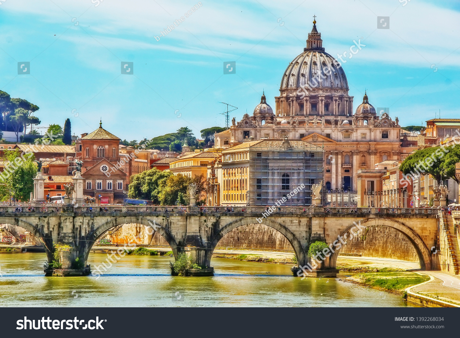 The Papal Basilica of St. Peter in the Vatican (St. Peter's Basilica), an Italian Renaissance church in Vatican City, the papal enclave within city of Rome, view from Tiber river on Ponte Sant'Angelo #1392268034