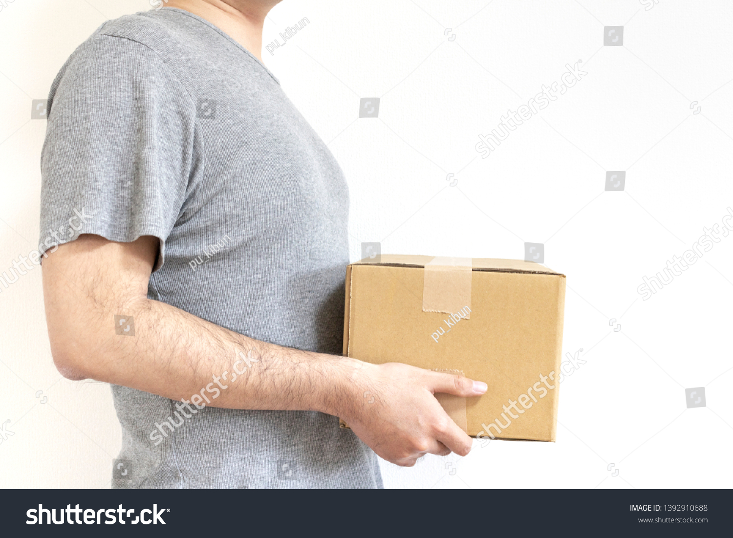 Standing man with cardboard box #1392910688