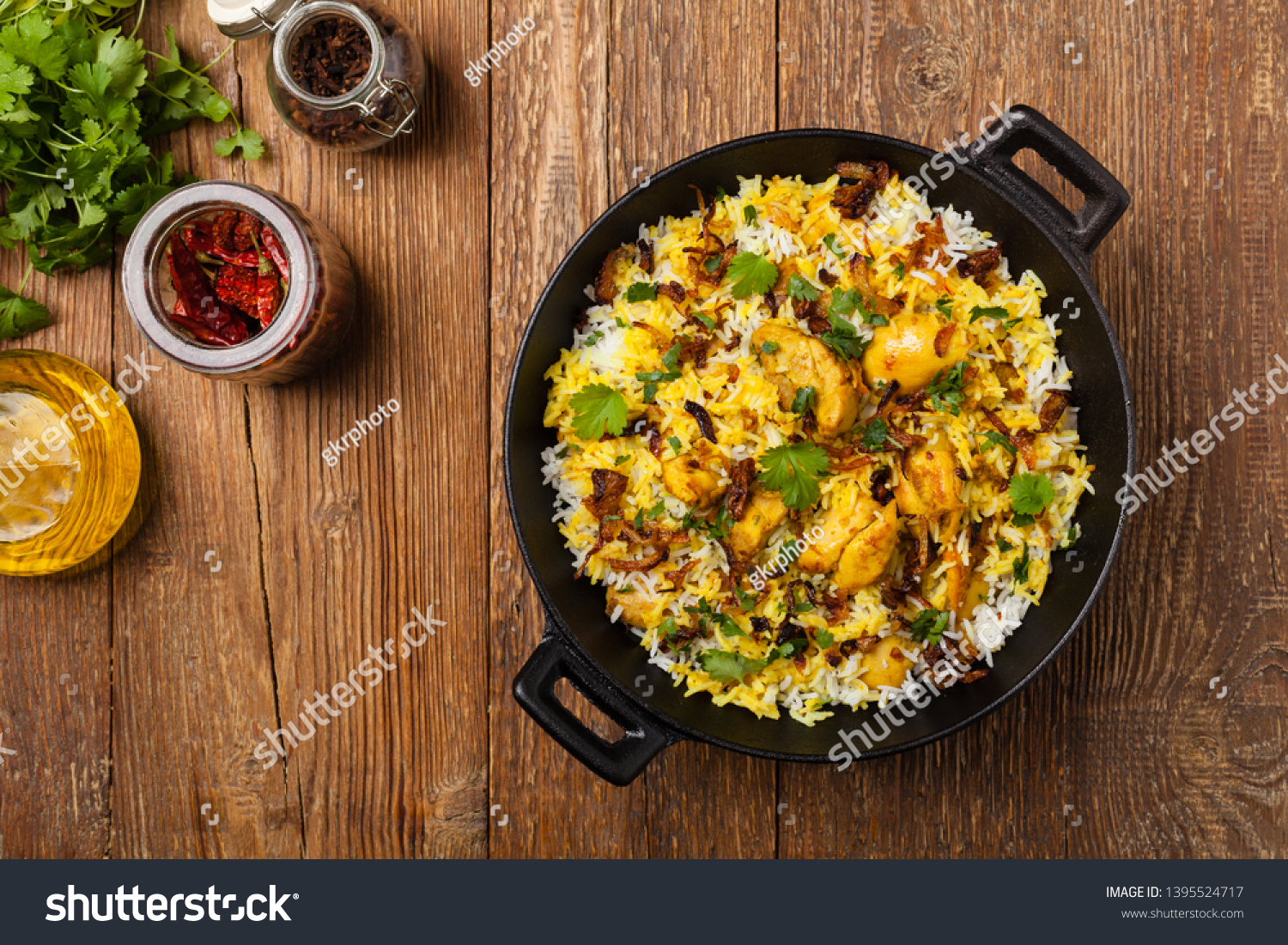 Biryani with chicken. Traditional Indian dish of rice and chicken marinated in spices and yoghurt.Top view. natural wooden background.  #1395524717