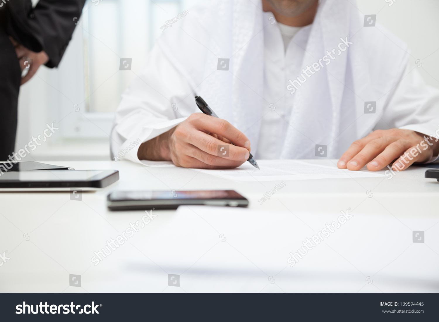 Close up of Arab businessman signing the contract. Focus is on hand #139594445