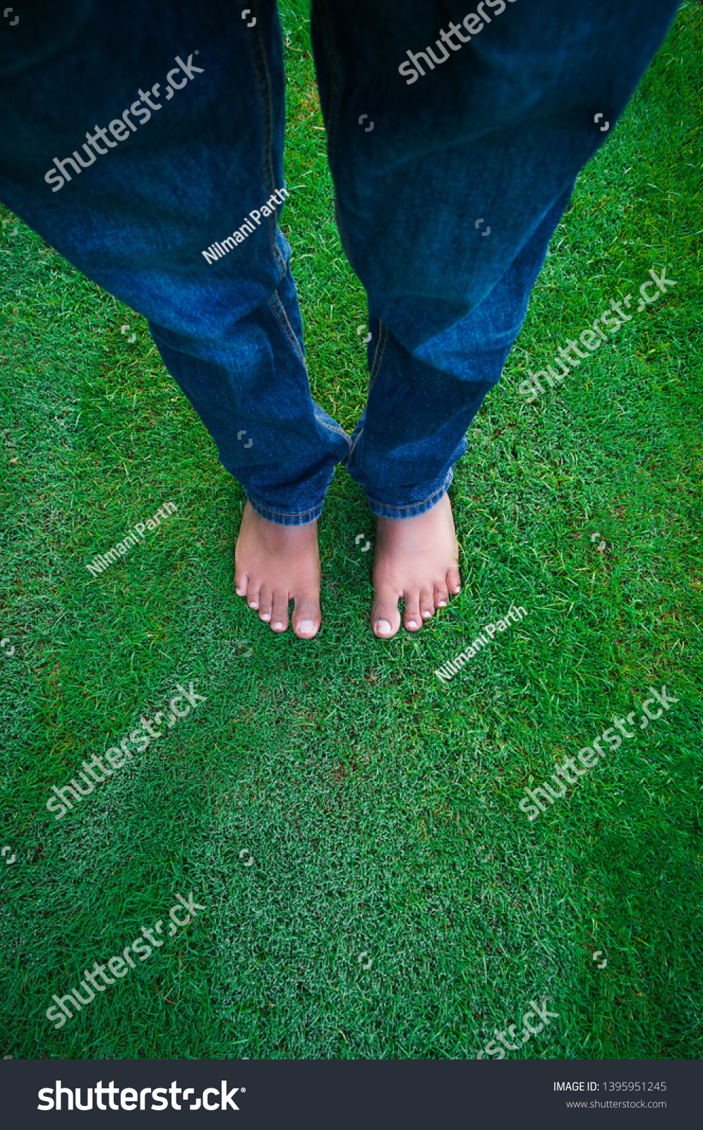             foot resting on green field                    #1395951245