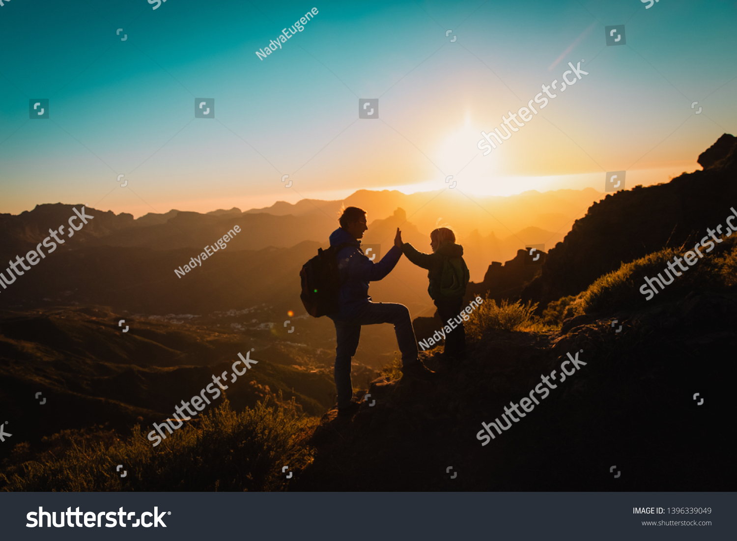 father and little daughter travel in mountains at sunset #1396339049