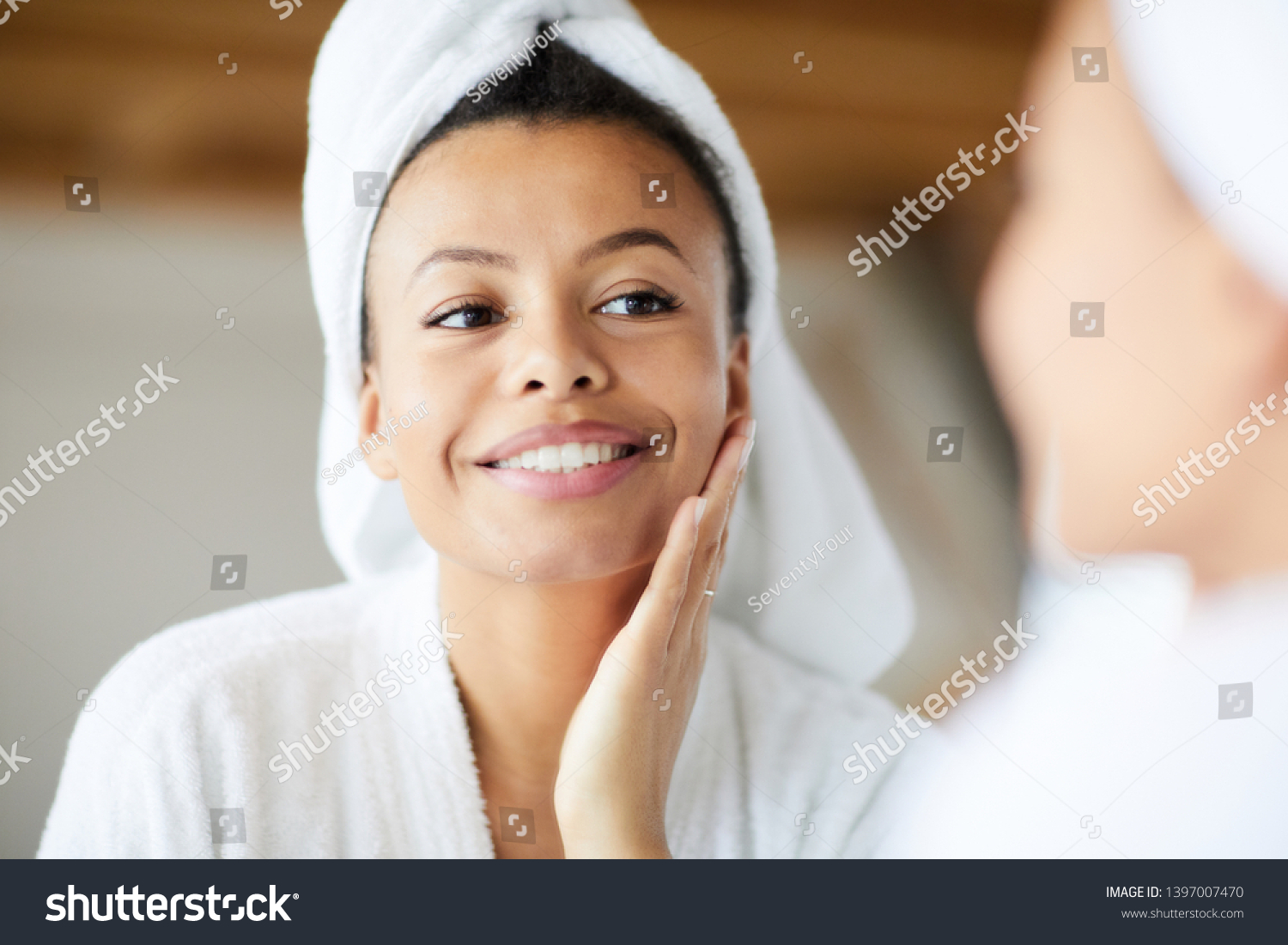 Head and shoulders portrait of  smiling Mixed-Race woman looking in mirror during morning routine, copy space #1397007470