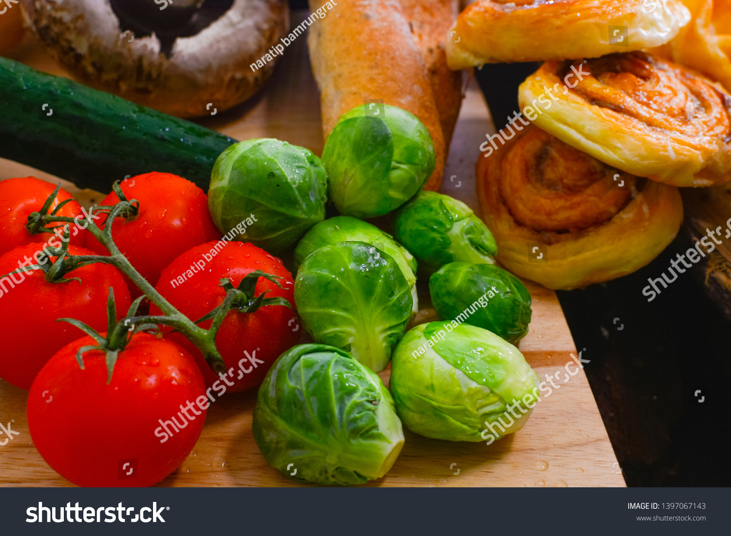 Fresh vegetables and fresh tomato,brussels sprouts, bread, cinnamon rolls, picture placement, still light, shadow #1397067143