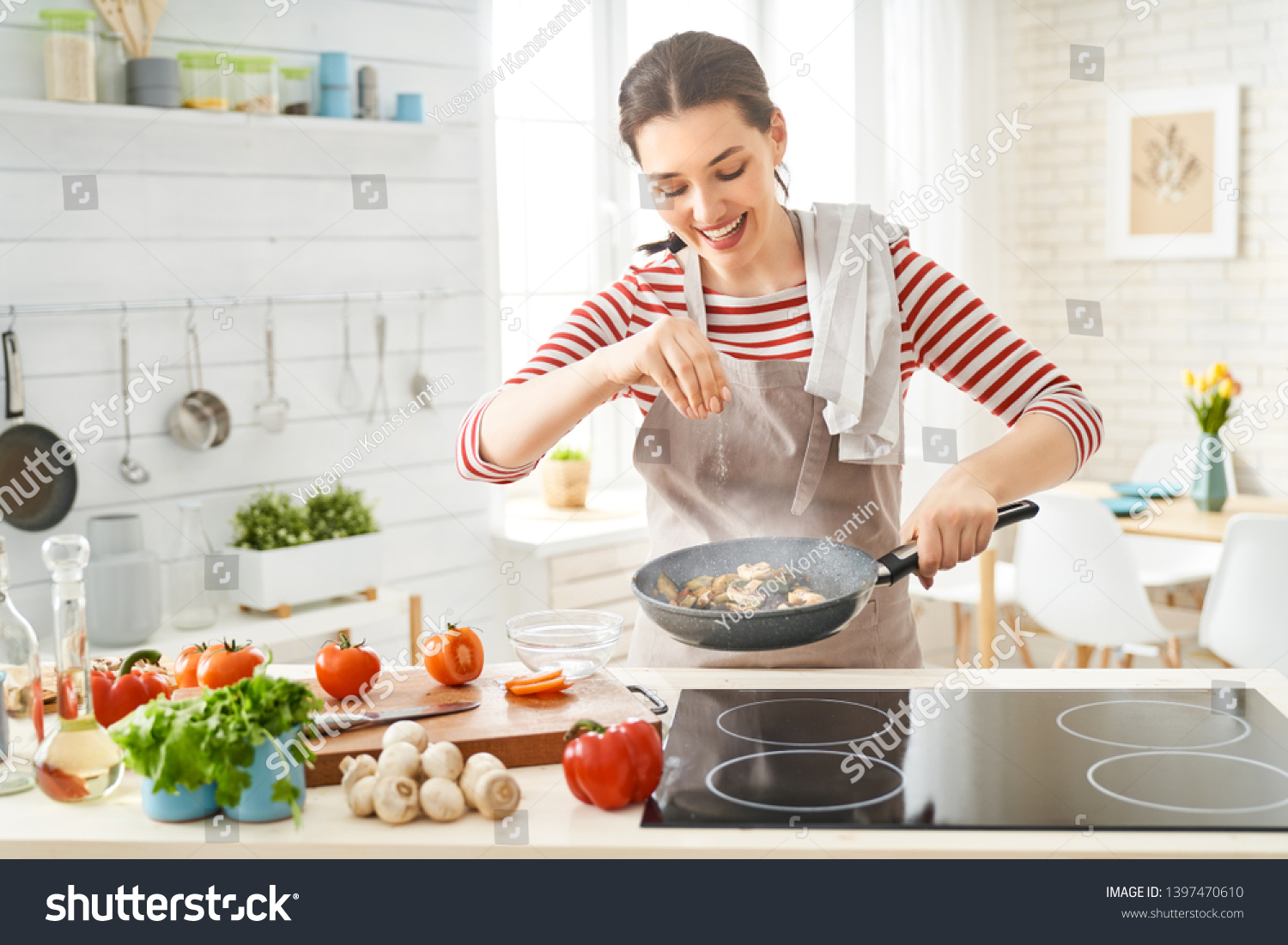 Healthy food at home. Happy woman is preparing the proper meal in the kitchen. #1397470610