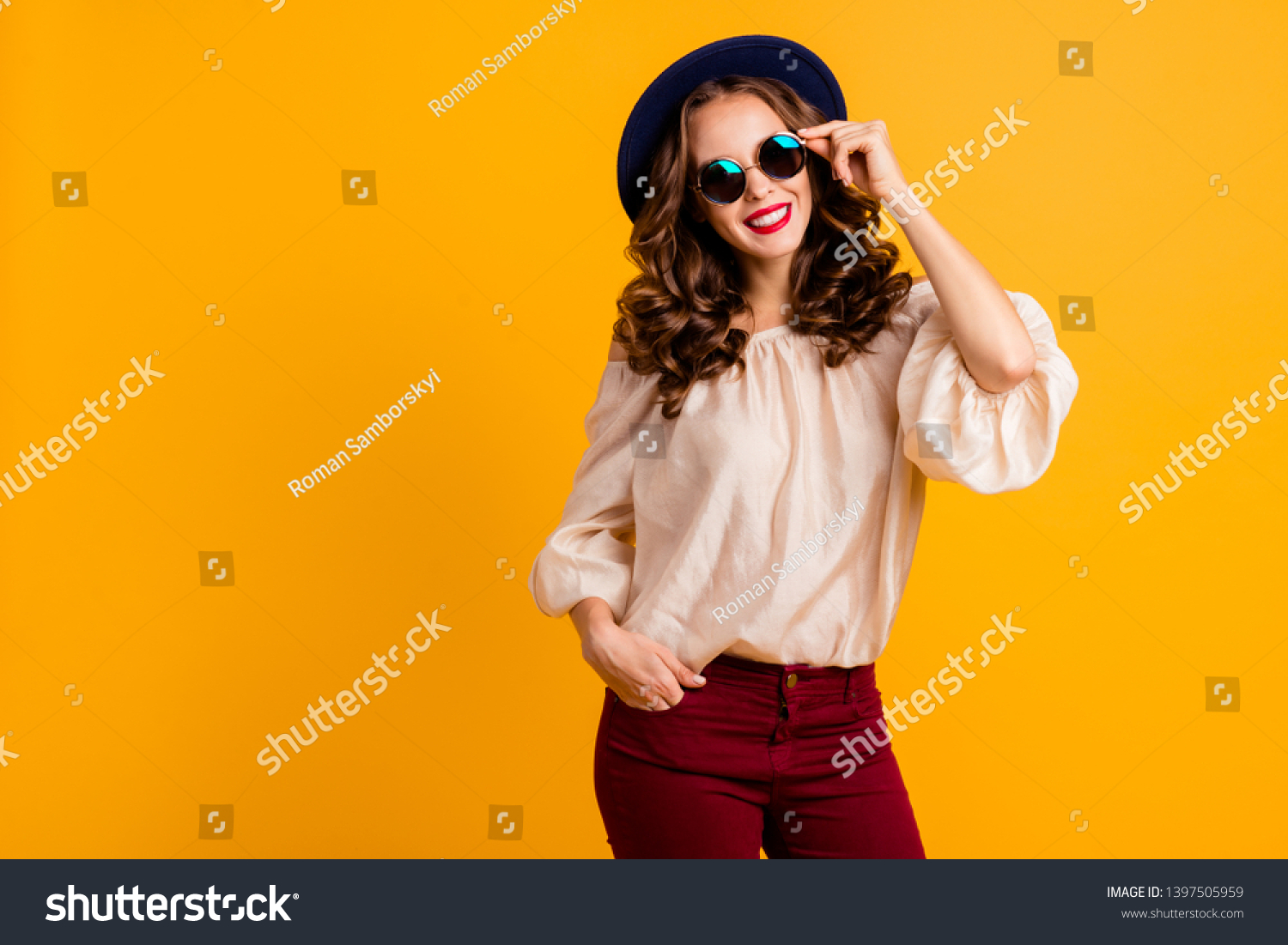 Portrait of her she nice-looking cool attractive fascinating lovely gorgeous pretty content cheerful cheery wavy-haired lady touching round glasses isolated over bright vivid shine yellow background #1397505959